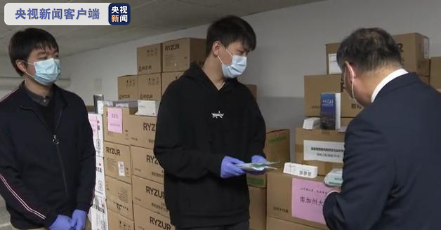 洛杉矶领事馆领事张平发放“健康包”与防疫指南。
