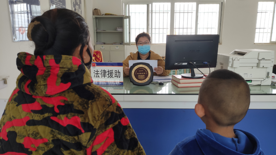 疫情期间,冯姣姣(中)在红河县司法局接待当事人